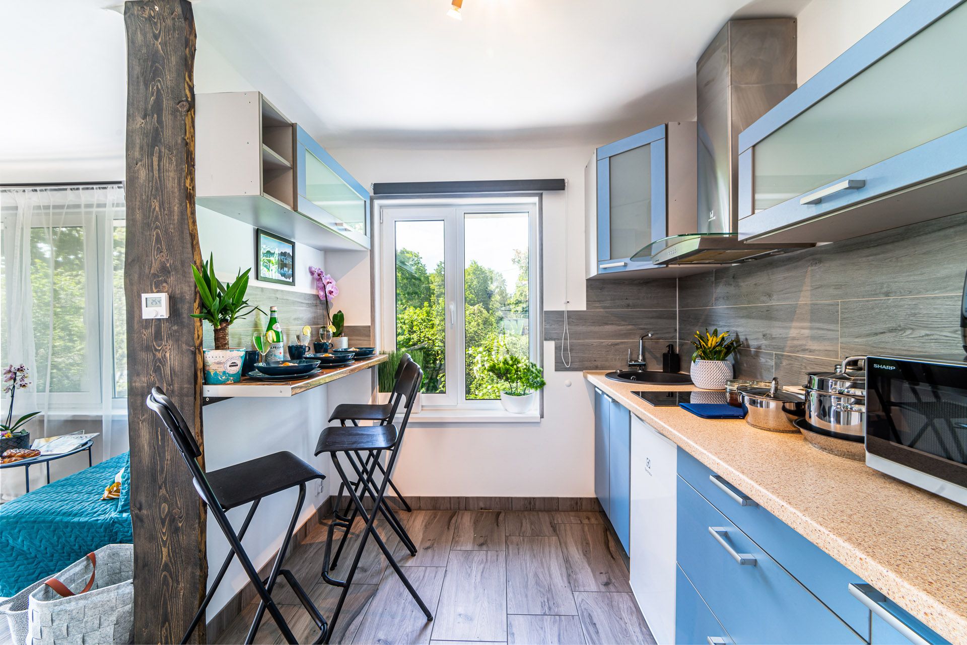 Kitchen with full cooking setup, including spices, oil and coffee machine, at Garden Apartments Riga
