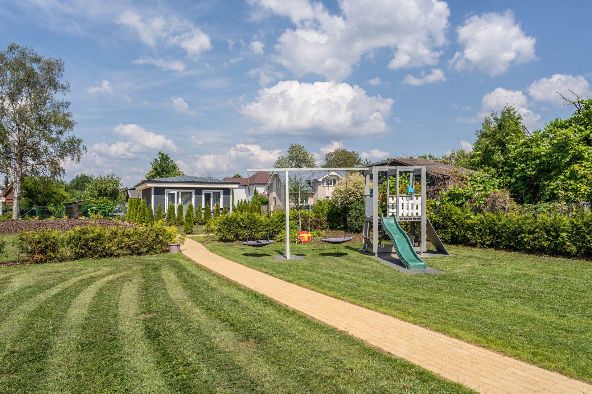 Colorful children’s playground in the garden at Garden Apartments Riga short-term rentals